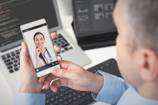 Doctor with a stethoscope on the smartphone screen. Telemedicine or telehealth concept.