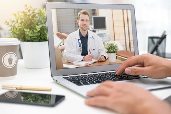 Doctor with a stethoscope on the computer laptop screen. Telemedicine or telehealth concept.